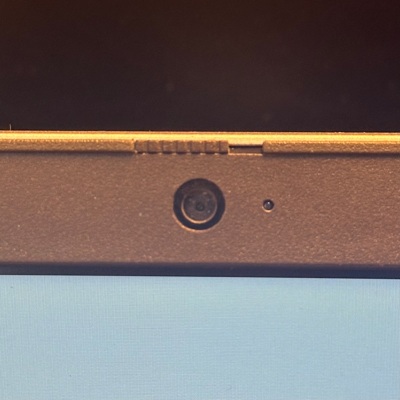 Laptop webcam with the cover switch open, uncovering the camera